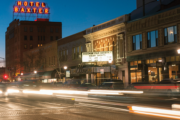 Cars drive down Main Street at twilight.