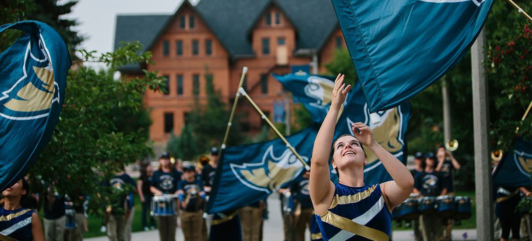 Color guard participants with flags in front of Montana Hall.