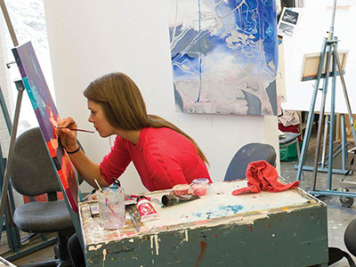A student works on a painting.