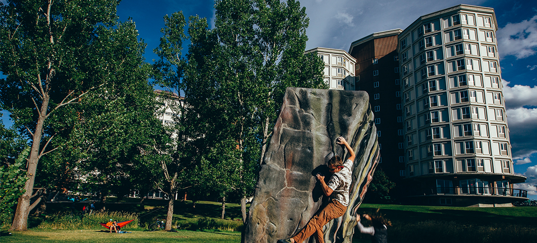A student boulders in front of Roskie Hall.
