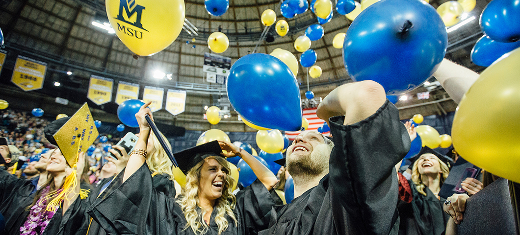 Students and balloons at graduation