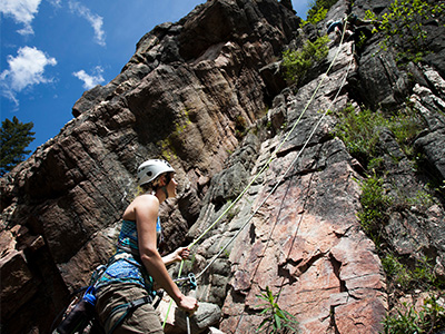 Group of students rock climbing during summer.