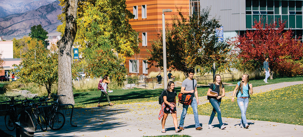 A group of students walk in front of Jabs Hall in fall.