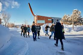 students walking past the Noodle art in the snow