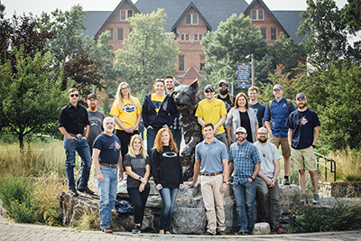 Students sit on building steps