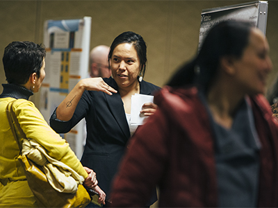 McNair scholar and Montana State University student Celina Brownotter explains her research to students and faculty