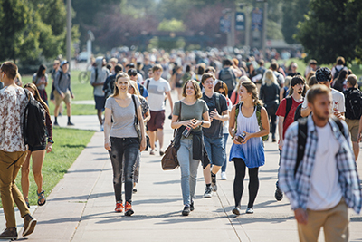 Students walking down Centennial Mall on a sunny day