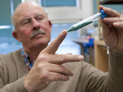 Barry Jacobsen holds a vile of a sample of an agricultural disease-fighting technology