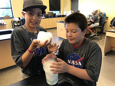 Middle school students experiment at a free STEM summer camp