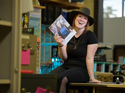 Portrait of Kate Chapin holding issue of The Artists magazine