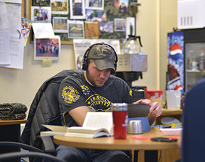 A student studying with books on a table