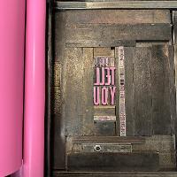The cover of the book set up in the bed of the press. 