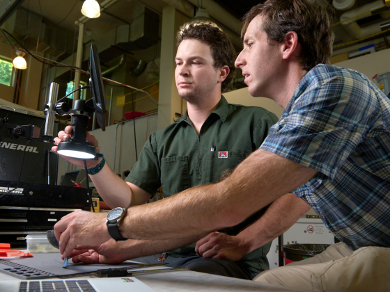 Two people looking through a microscope in a lab | MSU photo by Colter Peterson