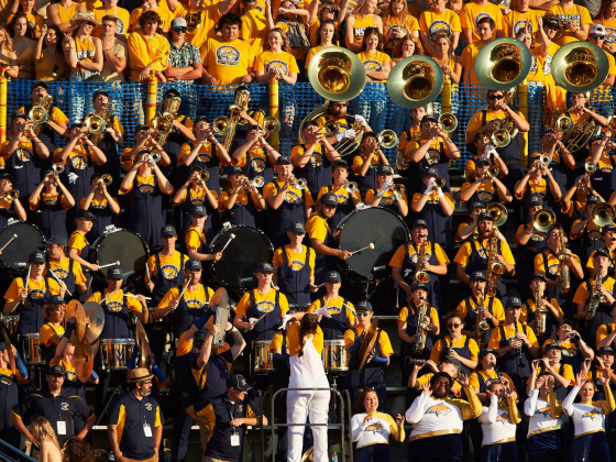 Fans stand behind the Spirt of the West band at a Montana State University Football game | 