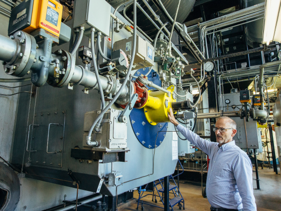 Duke Elliott gestures toward an industrial device