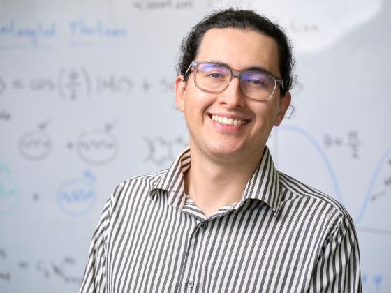 Portrait of Martin Mosquera standing in front of a white board covered with mathematics | MSU photo by Colter Peterson