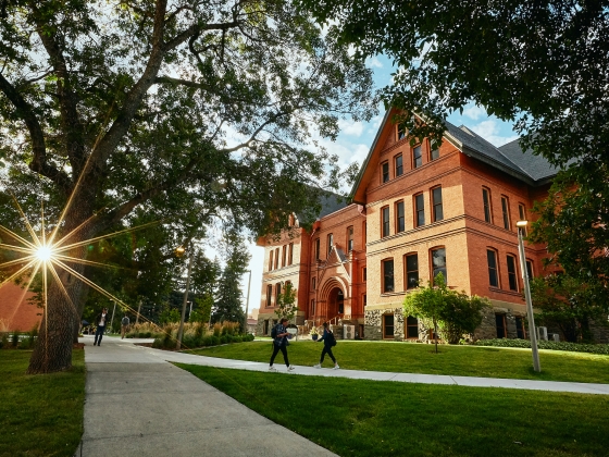 The sun rises over Wilson Hall at Montana State University on the left, while Montana Hall bathes in sunlight on the right side of the image during fall 2019. | Adrian Sanchez-Gonzalez/MSU