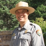 A photo of Jeff Mow who is dressed in a National Park Ranger university and a ranger wide-brimmed hat.