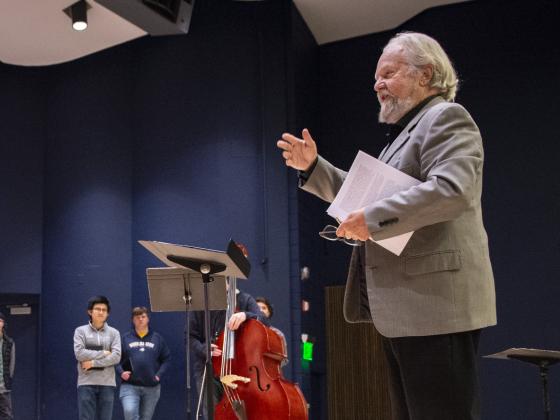Photo of Eric Funk on a stage conducting a group of musicians. | MSU photo by Colter Peterson