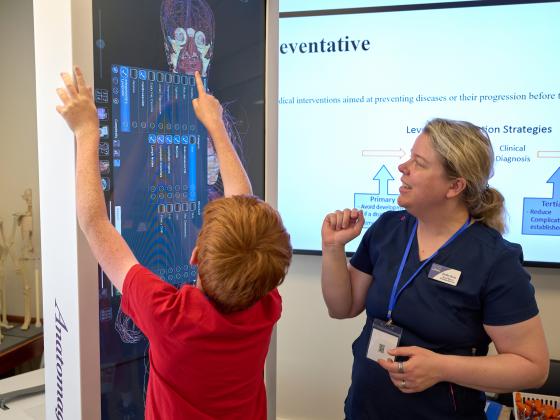 A teacher and a student interacting with a 7-foot-tall digital display showing human anatomy | MSU photo by Colter Peterson
