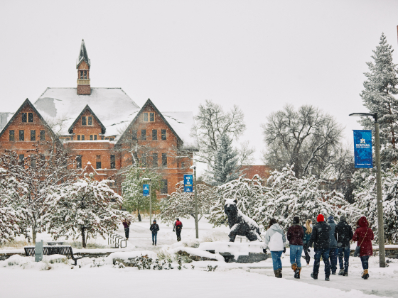 Students make their way through snowy sidewalks on campus at Montana State University as the first snow of the season arrives. | 