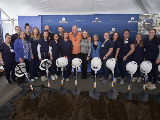 A group of MSU nursing students, administrators and Mark and Robyn Jones pose for a photo in front of shovels stuck into a pile of dirt. | 