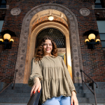 Portrait of Elena Garrard posing on steps outside a building
