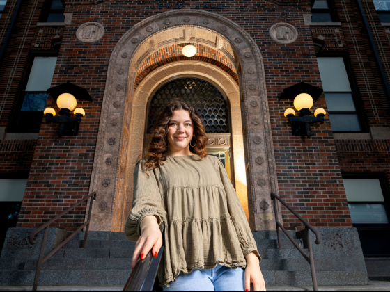 Portrait of Elena Garrard posing on steps outside a building | MSU Photo by Marcus "Doc" Cravens