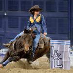 A woman on a horse competing in barrel racing