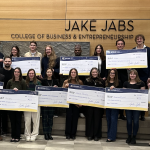 Students who made the finals of the annual Big Idea Challenge hold oversized checks.