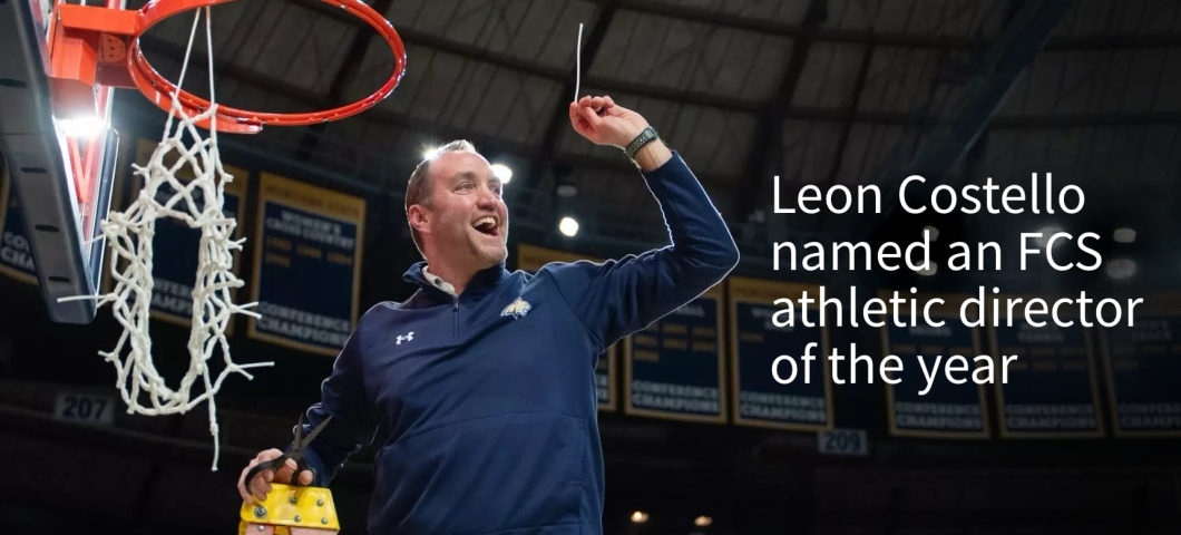 A promotional graphic featuring Montana State University Athletic Director Leon Costello standing on a ladder, smiling and holding up a cut piece of the basketball net in celebration. He is wearing a navy blue MSU pullover with the Bobcat logo, and the pa | Bobcat Athletics image