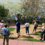 Students stand in a park.