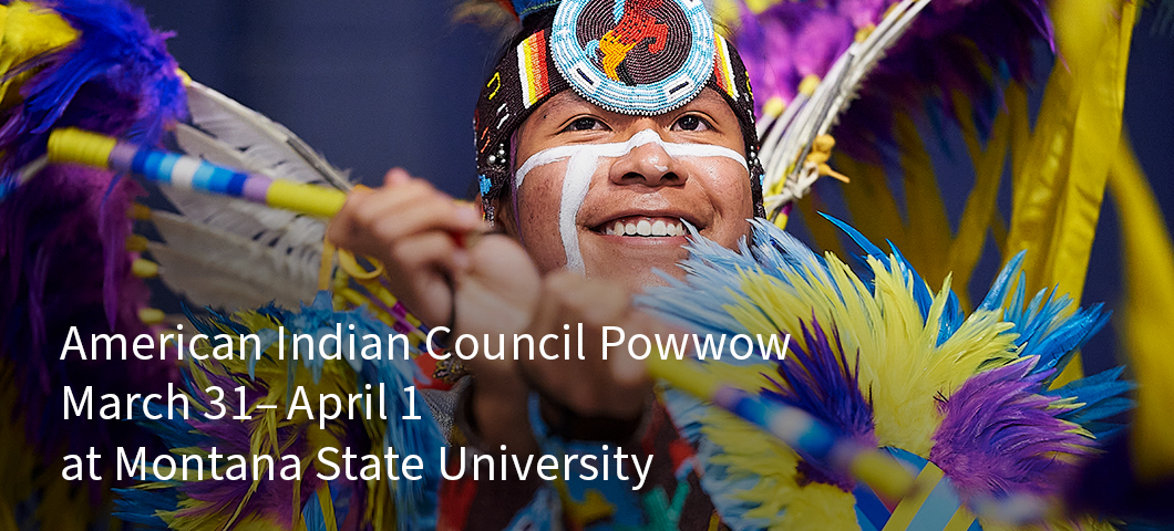A man in a Native American ceremonial outfit composed of colorful feathers and a beaded headband performs at a powwow. | MSU