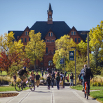Students walking on campus with Montana Hall in the background