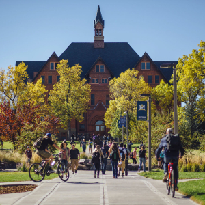 Students walking on campus with Montana Hall in the background