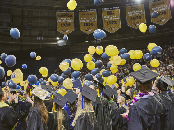 MSU graduates celebrating with blue and gold balloons at 2022 Spring Commencement | 