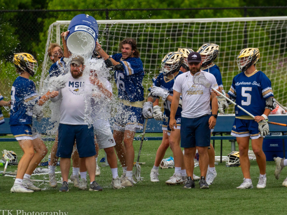 Lacrosse players douse their coach with a container of Gatorade | Image courtesy of Todd Kinney
