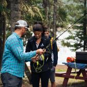 People setting up a fly fishing rod