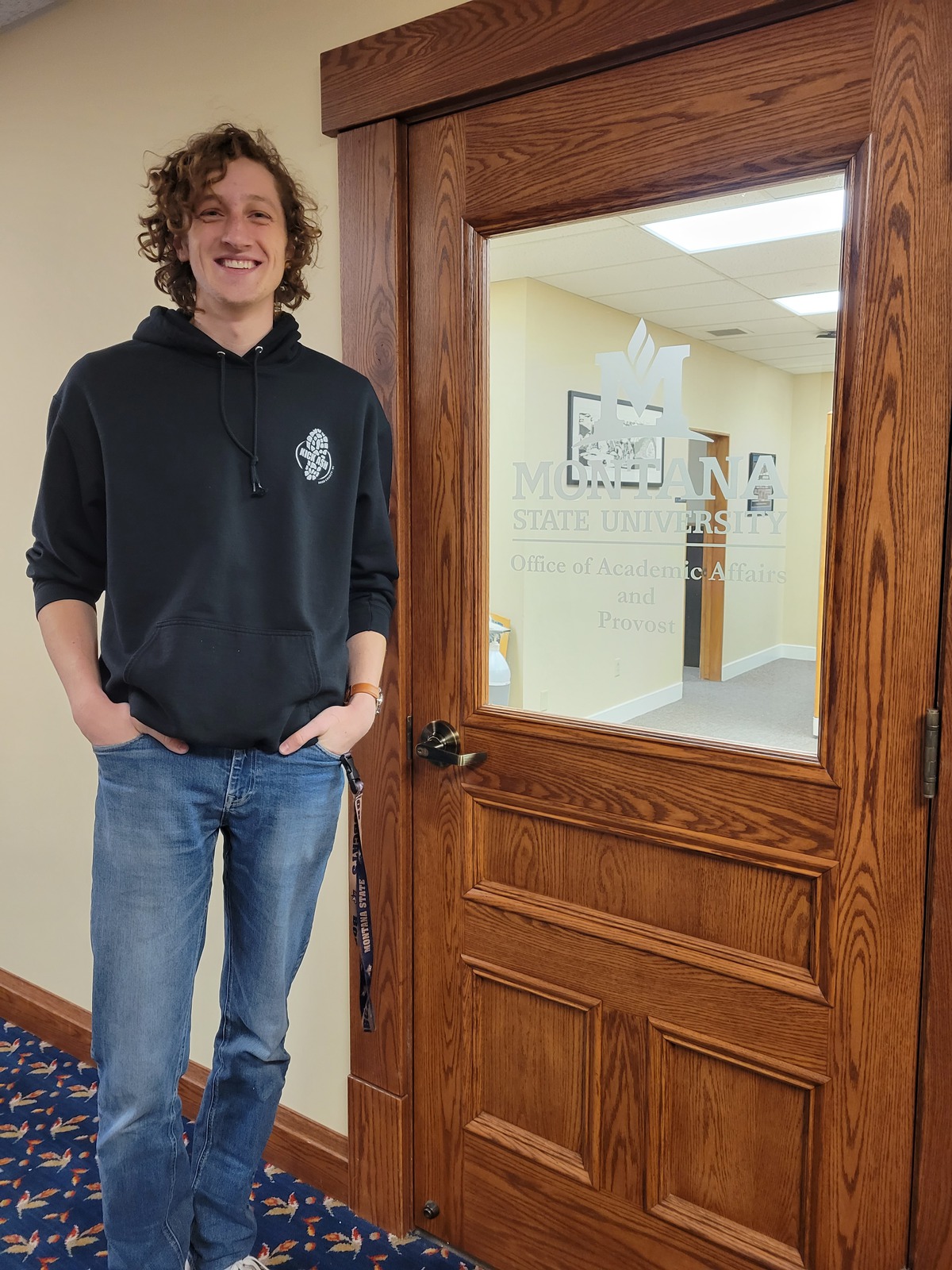Brady Ash standing infront of provost door