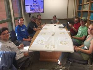 Early wort tasting with the MSU Barley Team. Jamie Sherman at front left and Joseph Jensen in green on the right.