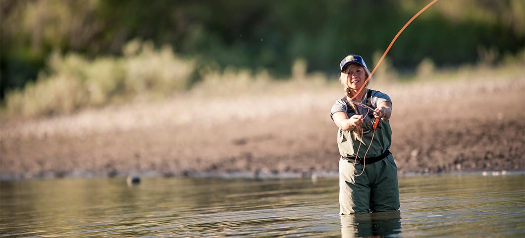 Young female casting a fishing line