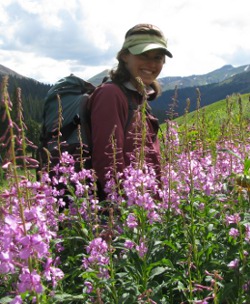 laura burkle standing in front of purple mountain flowers