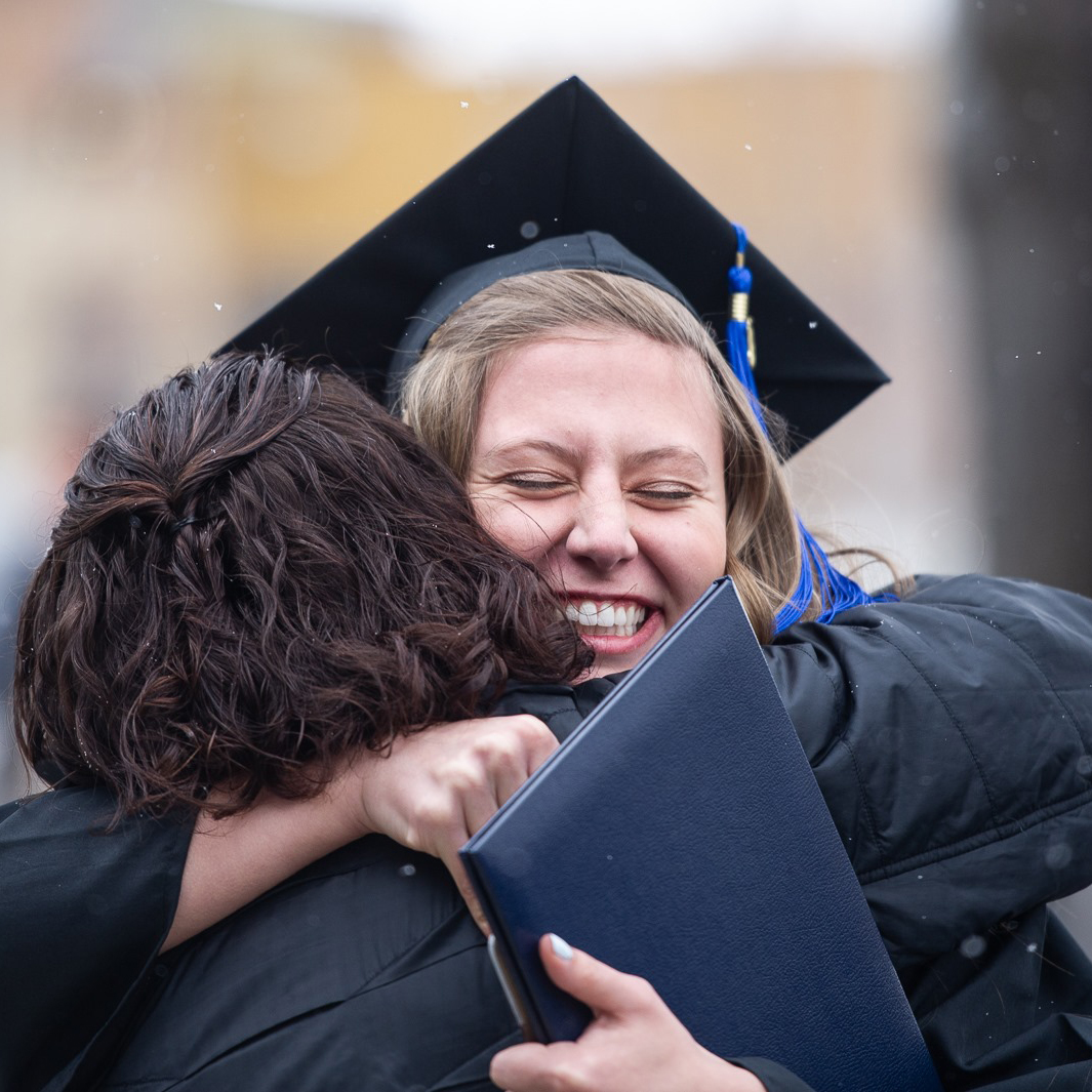 Student hugs their parent at MSU's Commencement Exercises