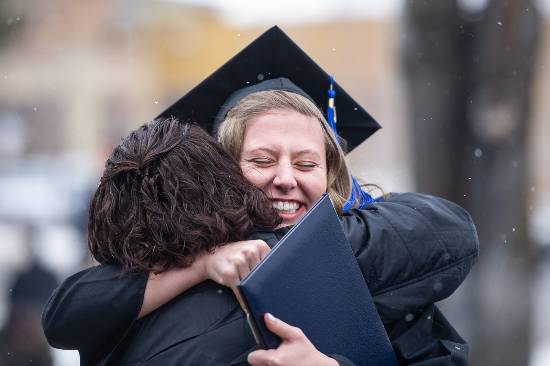 Student hugging her mother at Commencement