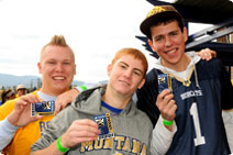 Students smiling showing off their CatCards