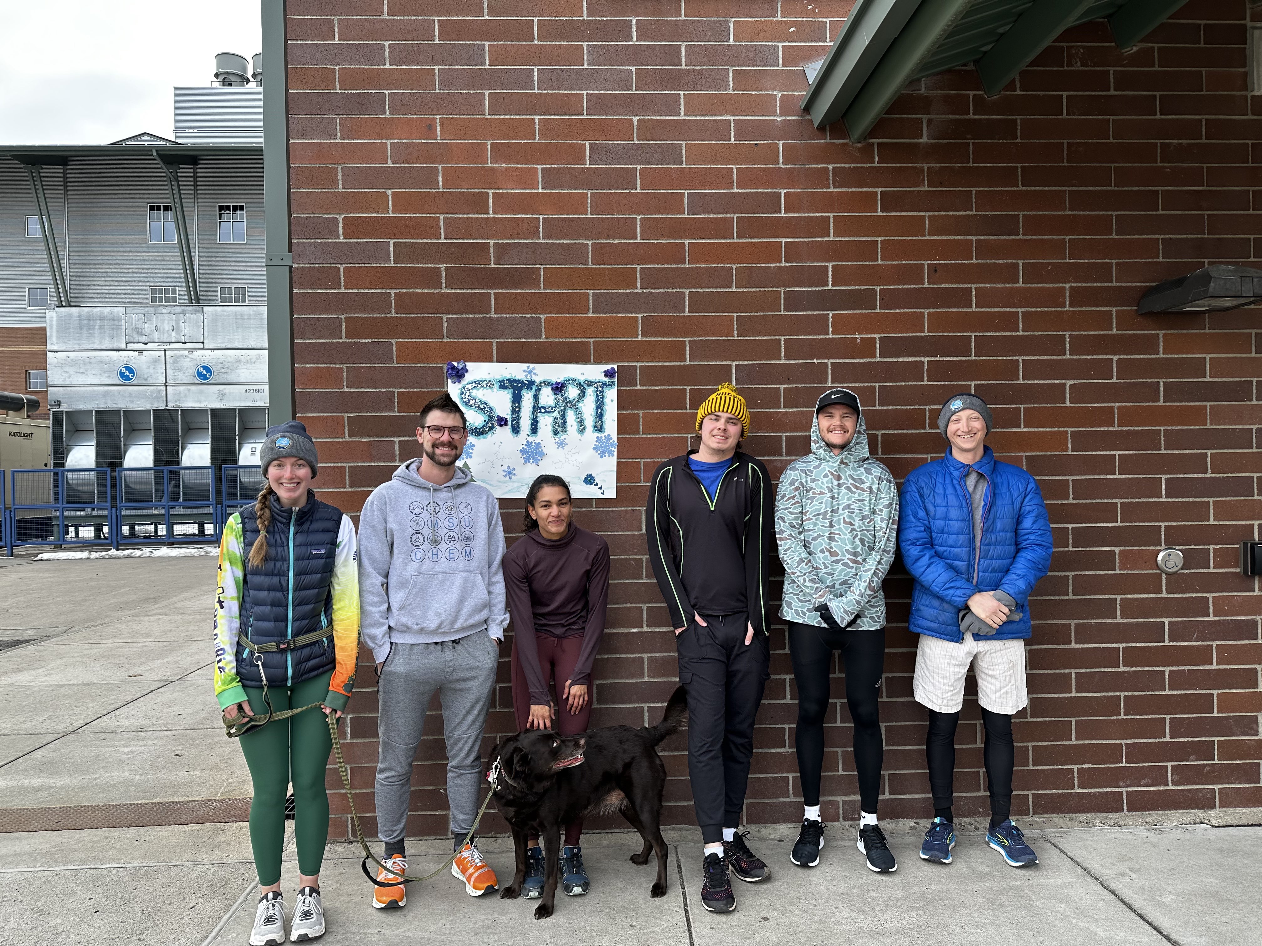 Grad students in front of our start line at the fun run in 2023