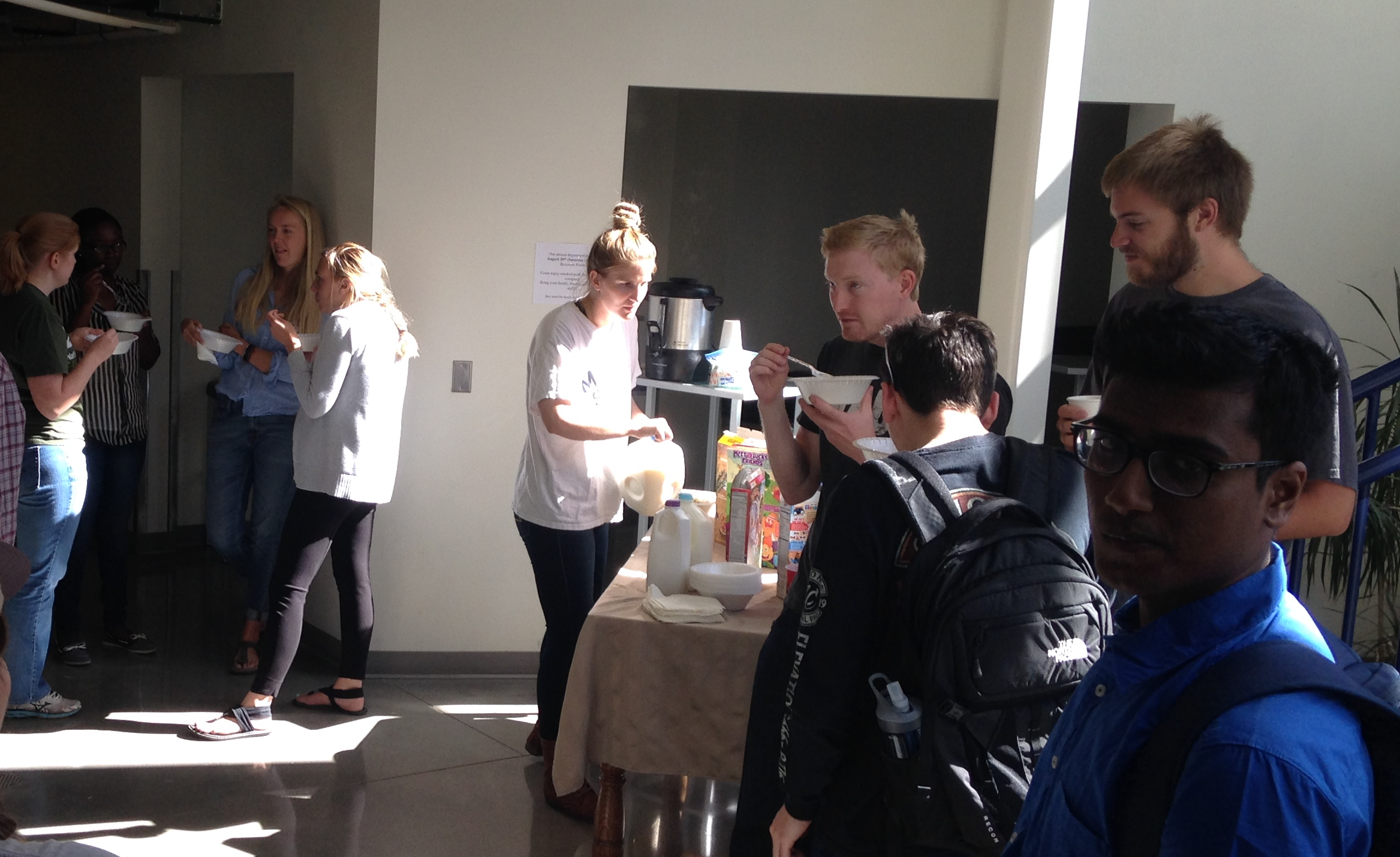 grad students eating cereal at a morning breakfast event from 2019