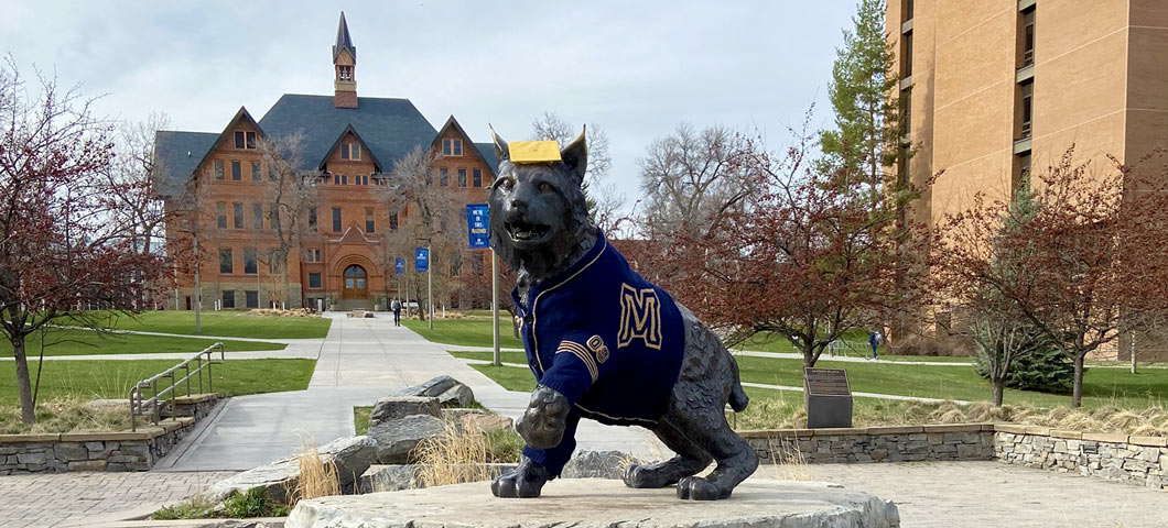 Spirit dressed in a mortarboard and collegiate sweater to celebrate Spring Commencement in 2023.