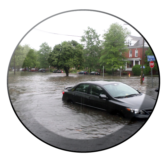 Car submerged in urban flood waters.
