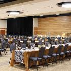 Image of decorated long table with round tables in background.